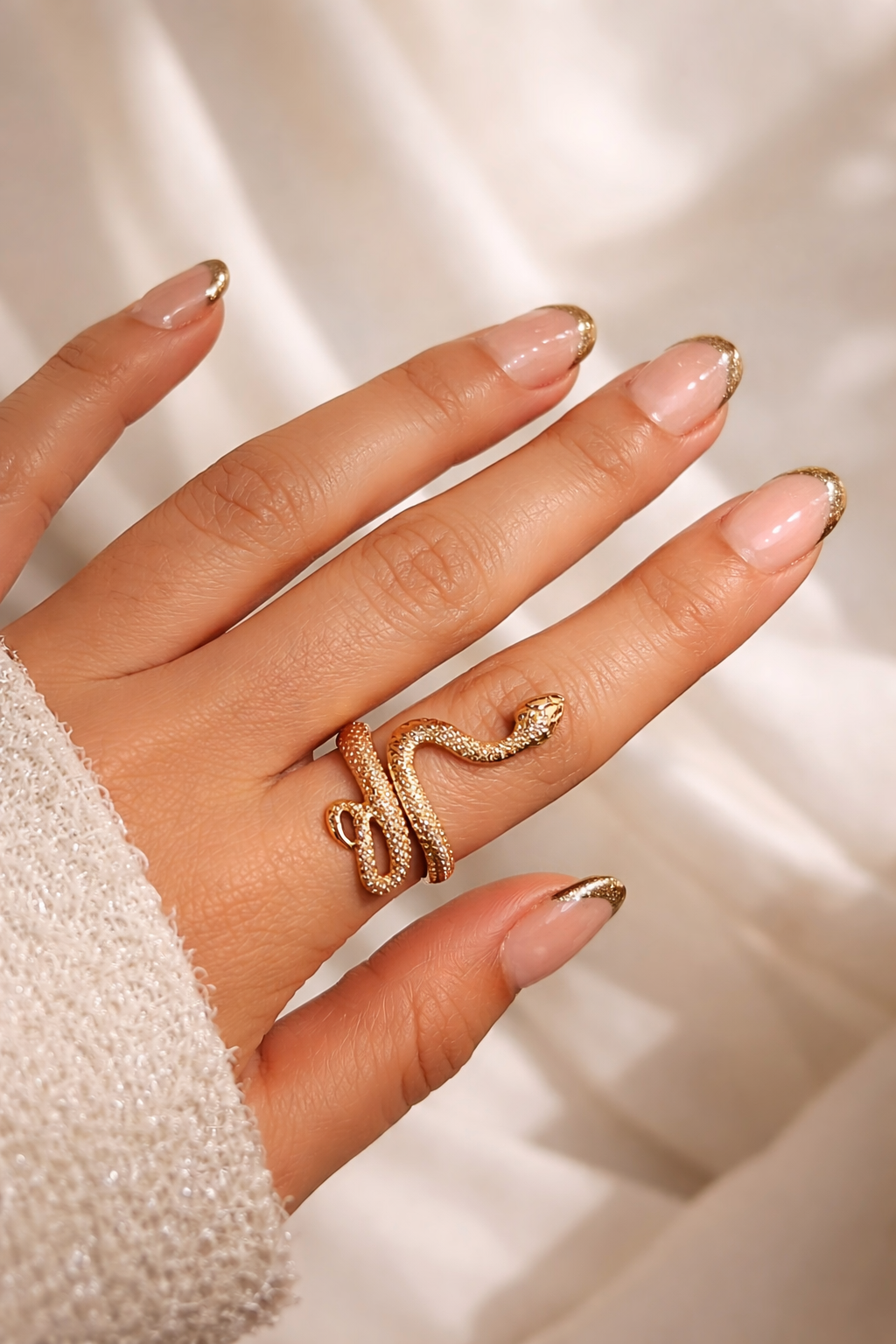 Snake-shaped gold ring with coiled serpent design and detailed scale texture