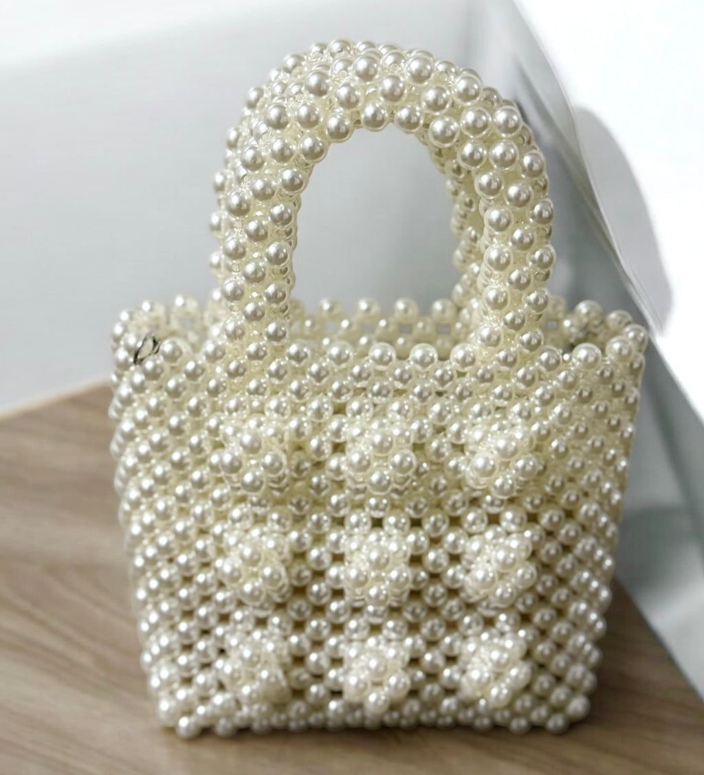 Pearl-embellished evening bag with white pearl beading and gold-plated frame