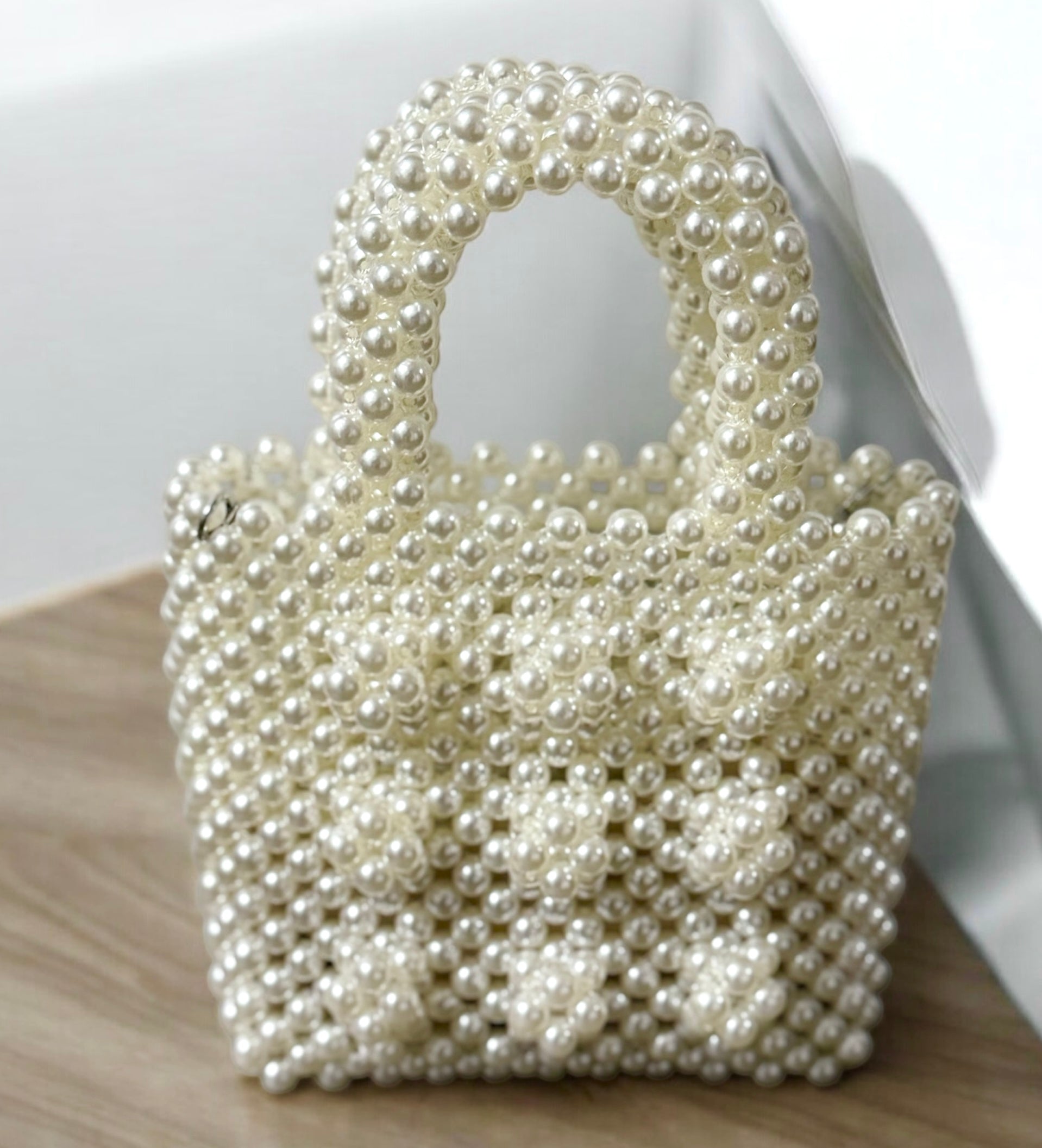 Pearl-embellished evening bag with white pearl beading and gold-plated frame