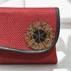 Burgundy evening clutch with rich textured surface and gold clasp hardware