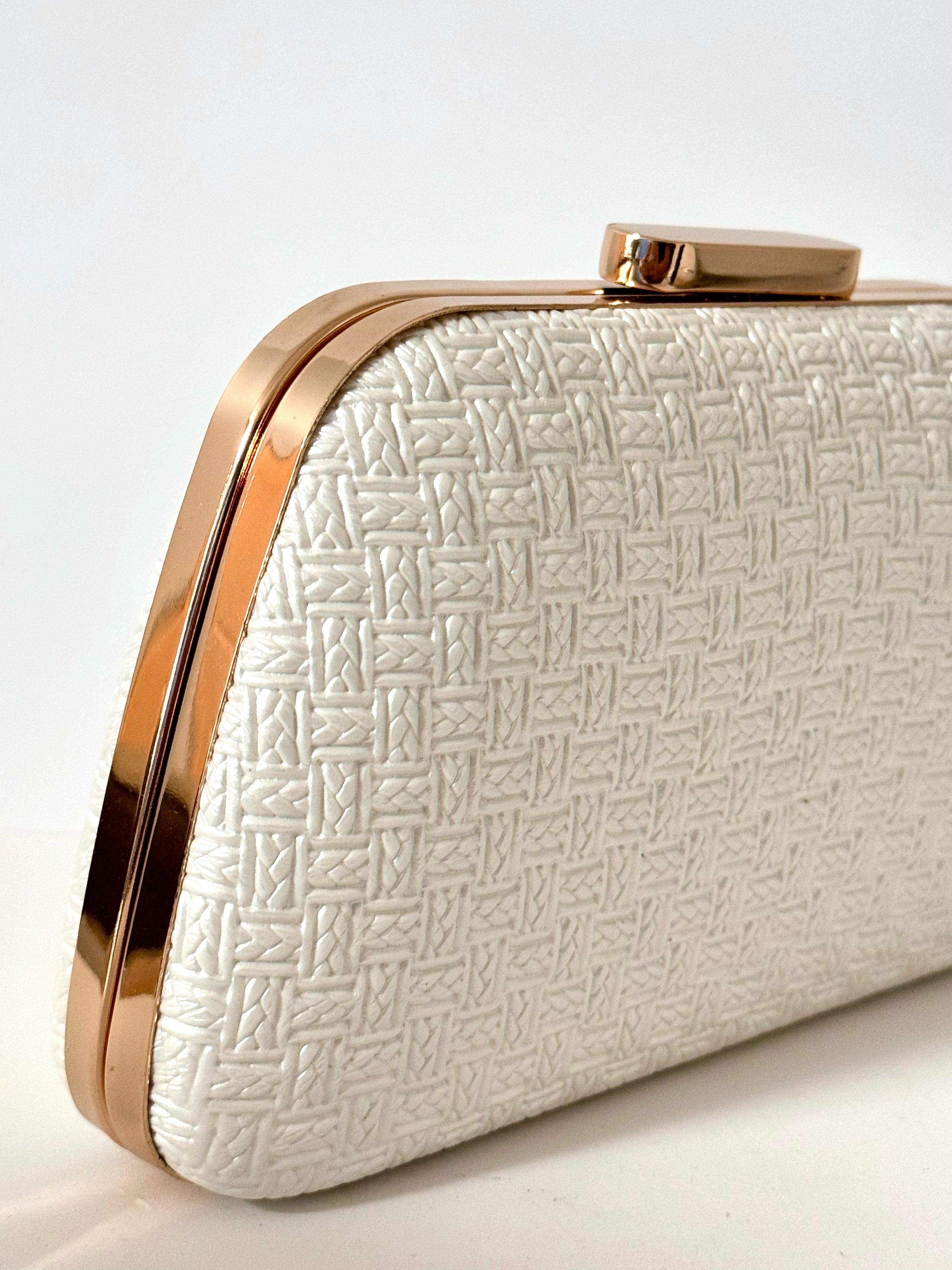 Geometric white evening purse with structured shell pattern and gold clasp
