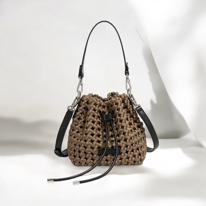 Handcrafted bucket bag in neutral tone with buckle closure and top handle