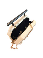 Clutch bag with gold chain strap on a white background