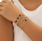 Evil eye bracelet stack with blue enamel beads and gold-plated chain links