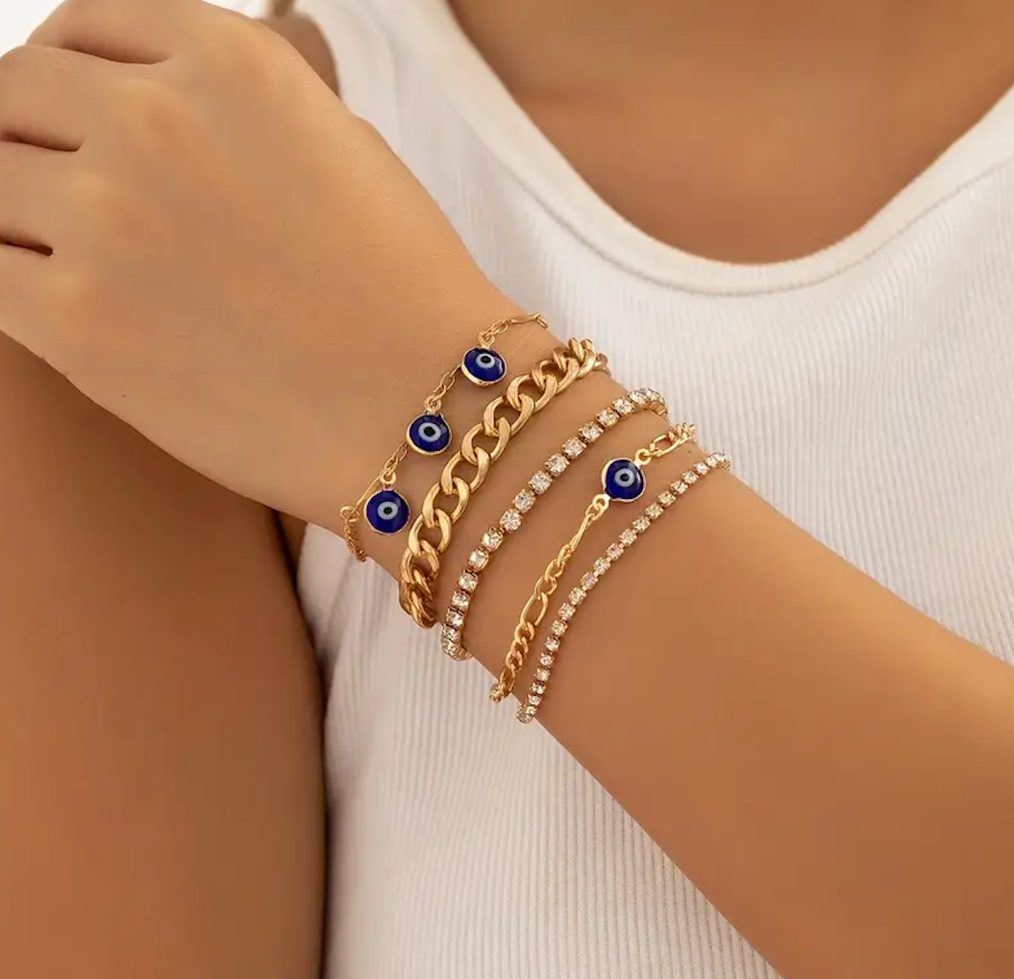 Evil eye bracelet stack with blue enamel beads and gold-plated chain links