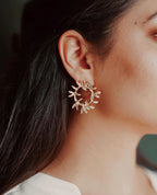 Revolve hoop earrings with twisted gold-plated design and lightweight construction